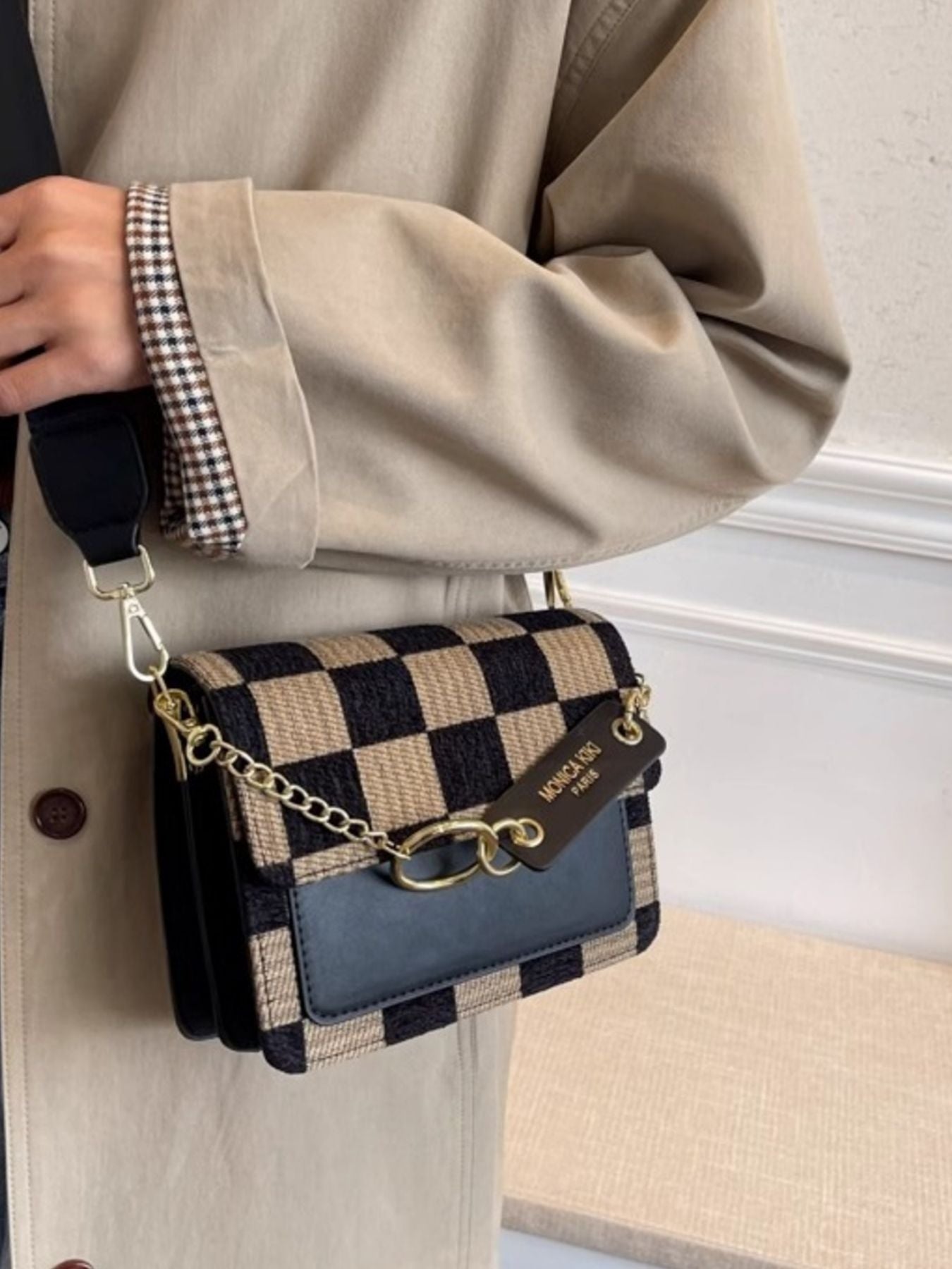 Mini checkered flap crossbody bag in beige and black with a gold chain strap.