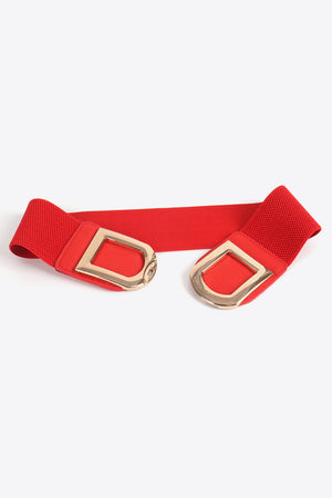 Red elastic belt with double gold D-shaped buckles and textured ends.