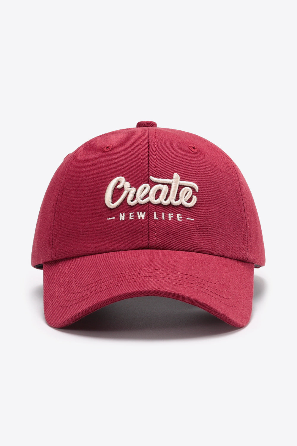Deep Red baseball cap with embroidered "Create New Life" text, adjustable strap.