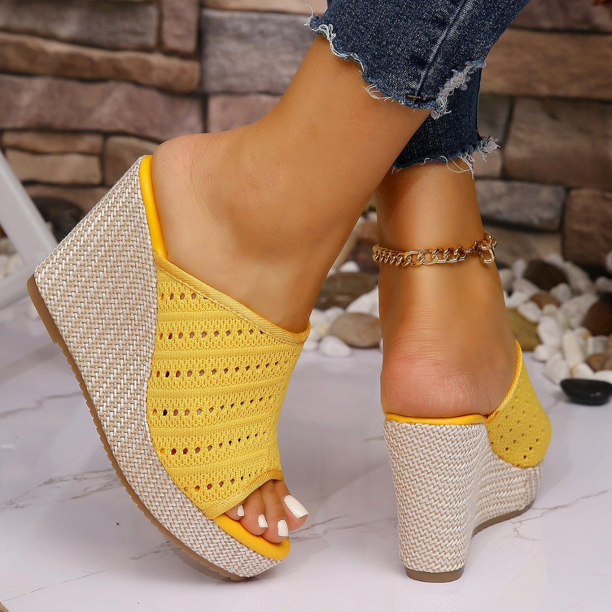Yellow perforated espadrille wedge sandals with woven wedge detail.