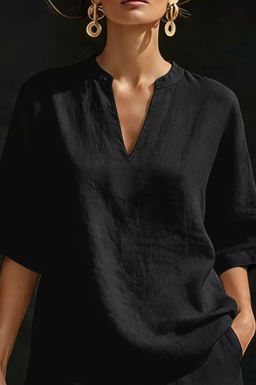 Black notched V-neck loungewear top with 3/4 sleeves and pockets.
