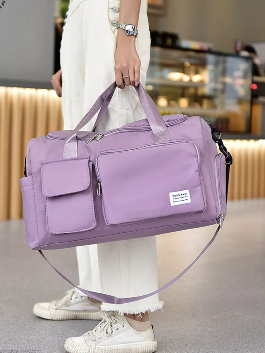 Purple Oxford cloth travel bag with multiple exterior pockets and a detachable strap.