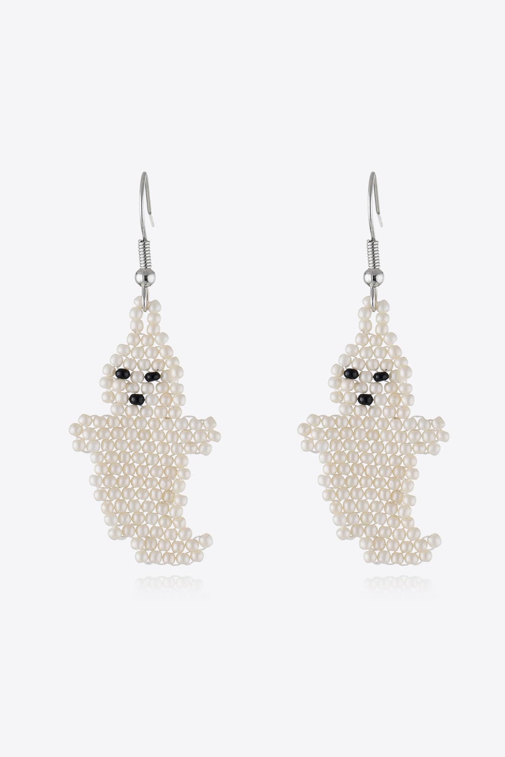 Ivory beaded ghost fringe earrings with black bead eyes and mouth.