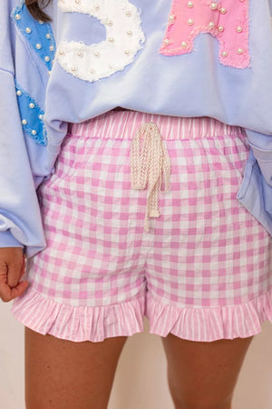 Charming pink gingham cotton shorts with drawstring and ruffle hem.