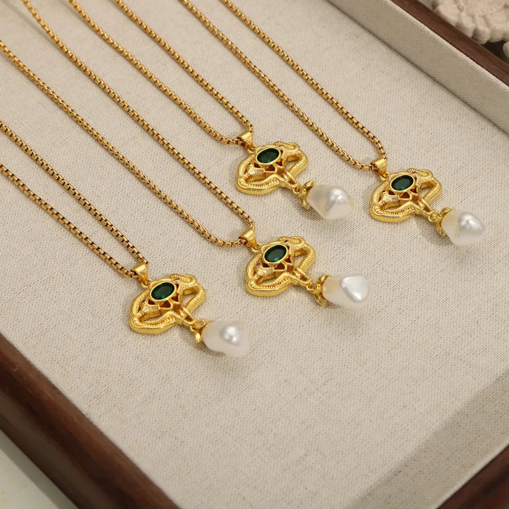 Gold botanical pearl drop pendant necklace with green gemstone detail