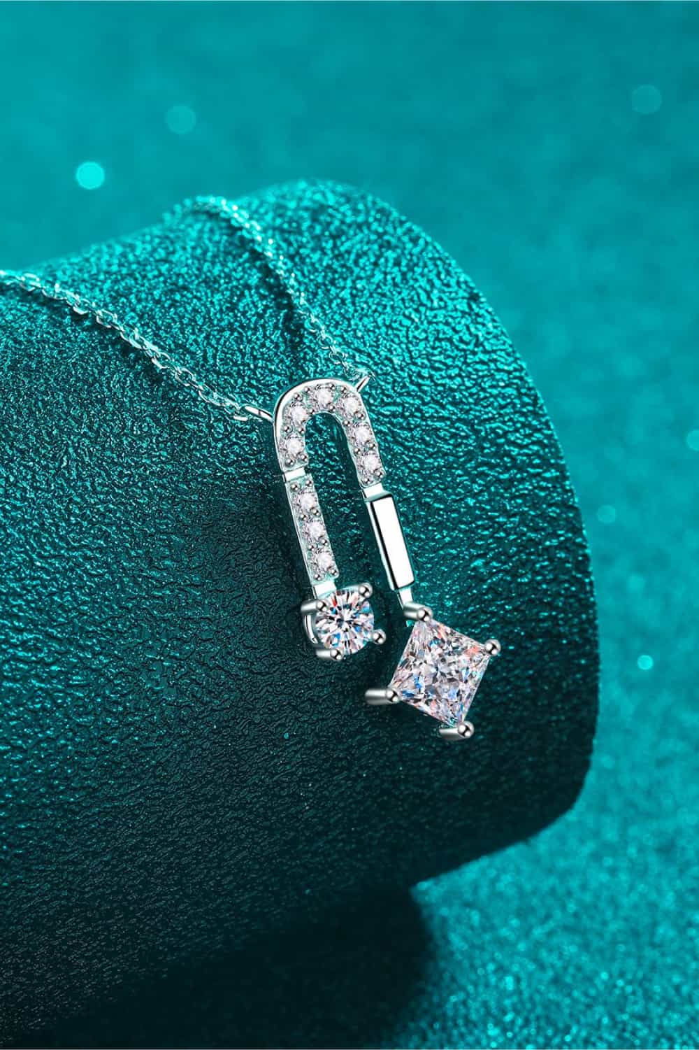 Silver geometric moissanite pendant necklace with clear cubic zirconia stones.
