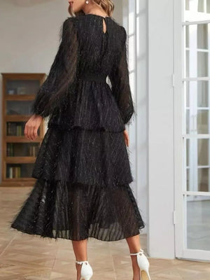 Black tiered midi dress with balloon sleeves and textured overlay.