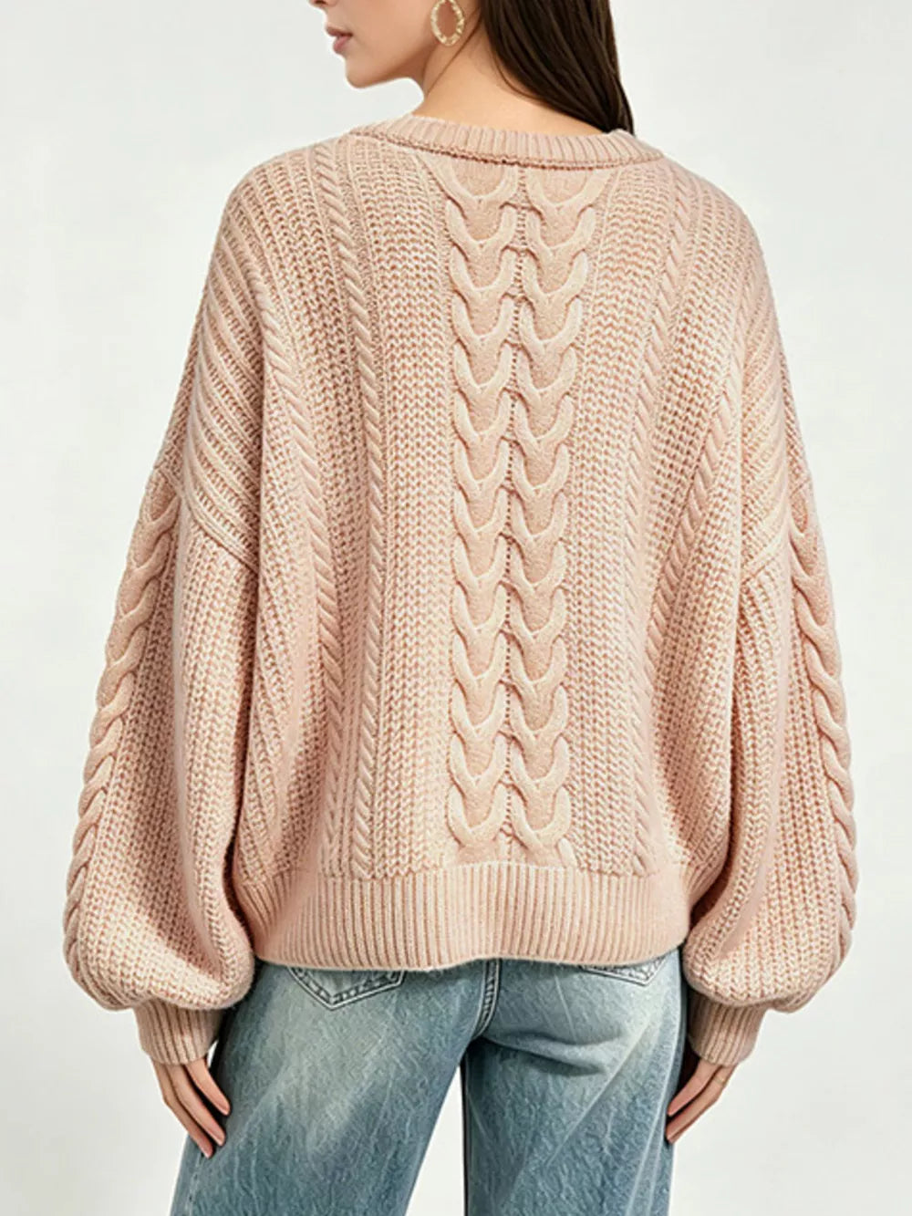 Beige pullover sweater featuring oversized and cable knit