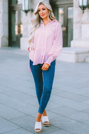 Blush pink pinstripe blouse with balloon sleeves and smocked cuffs, worn with blue jeans.