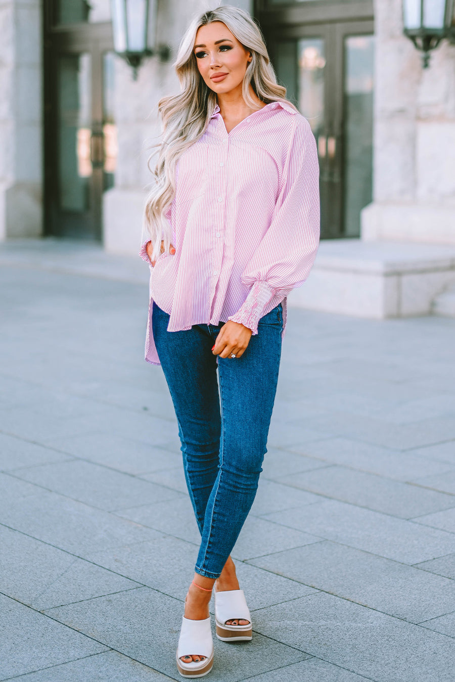 Blush pink pinstripe blouse with balloon sleeves and smocked cuffs, worn with blue jeans.