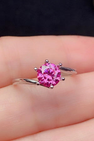 Radiant pink moissanite solitaire ring with a silver band.