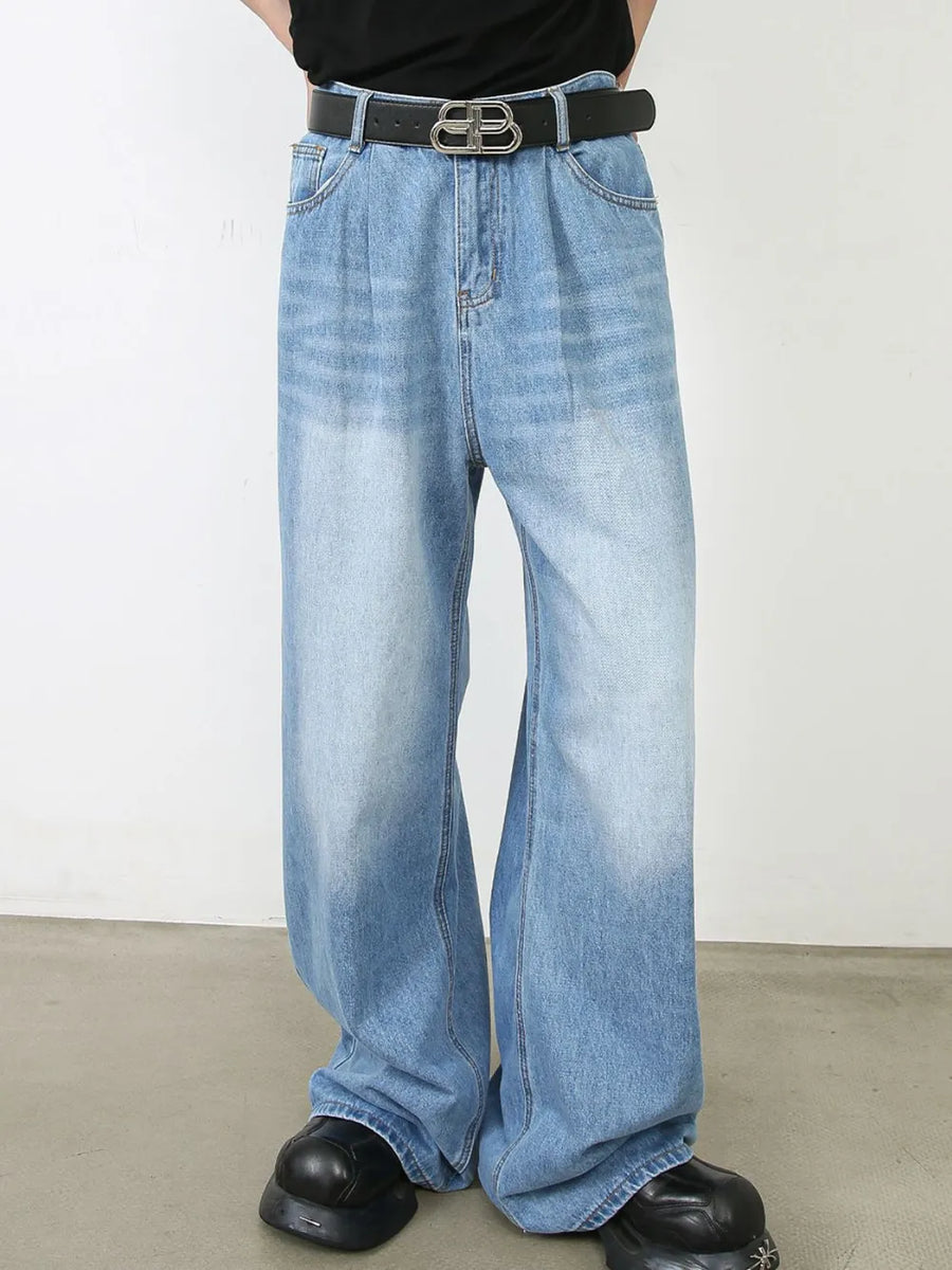 Light blue denim palazzo jeans with pleats and a faded wash.