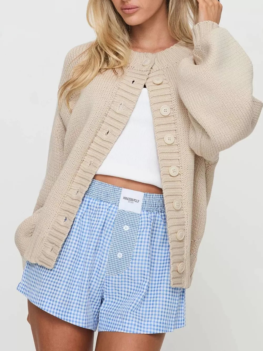 cardigan in light beige featuring buttoned and relaxed fit