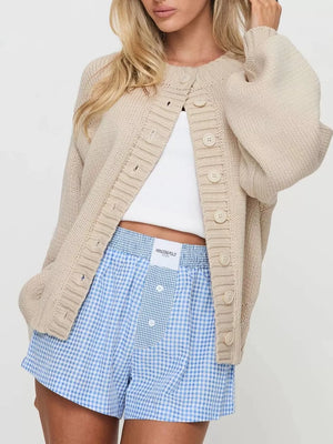 cardigan in light beige featuring buttoned and relaxed fit