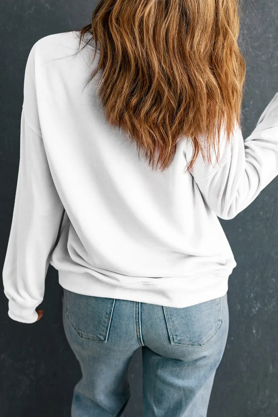 White crewneck sweatshirt with "LUCKY" graphic detail on back, casual style.