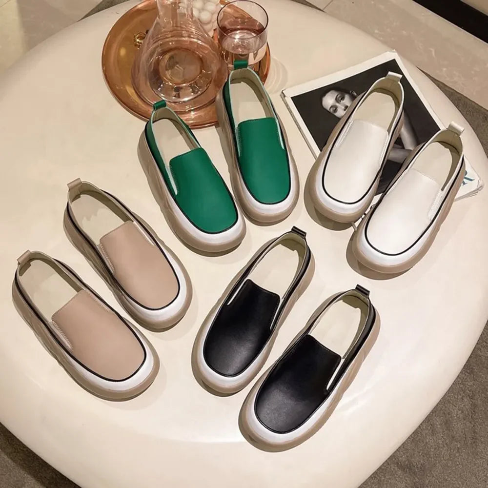 Sculpted platform slip-on sneakers in ivory, khaki, turquoise, and black with white soles.