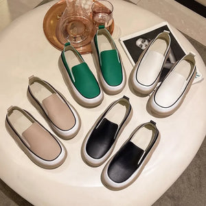 Sculpted platform slip-on sneakers in ivory, khaki, turquoise, and black with white soles.