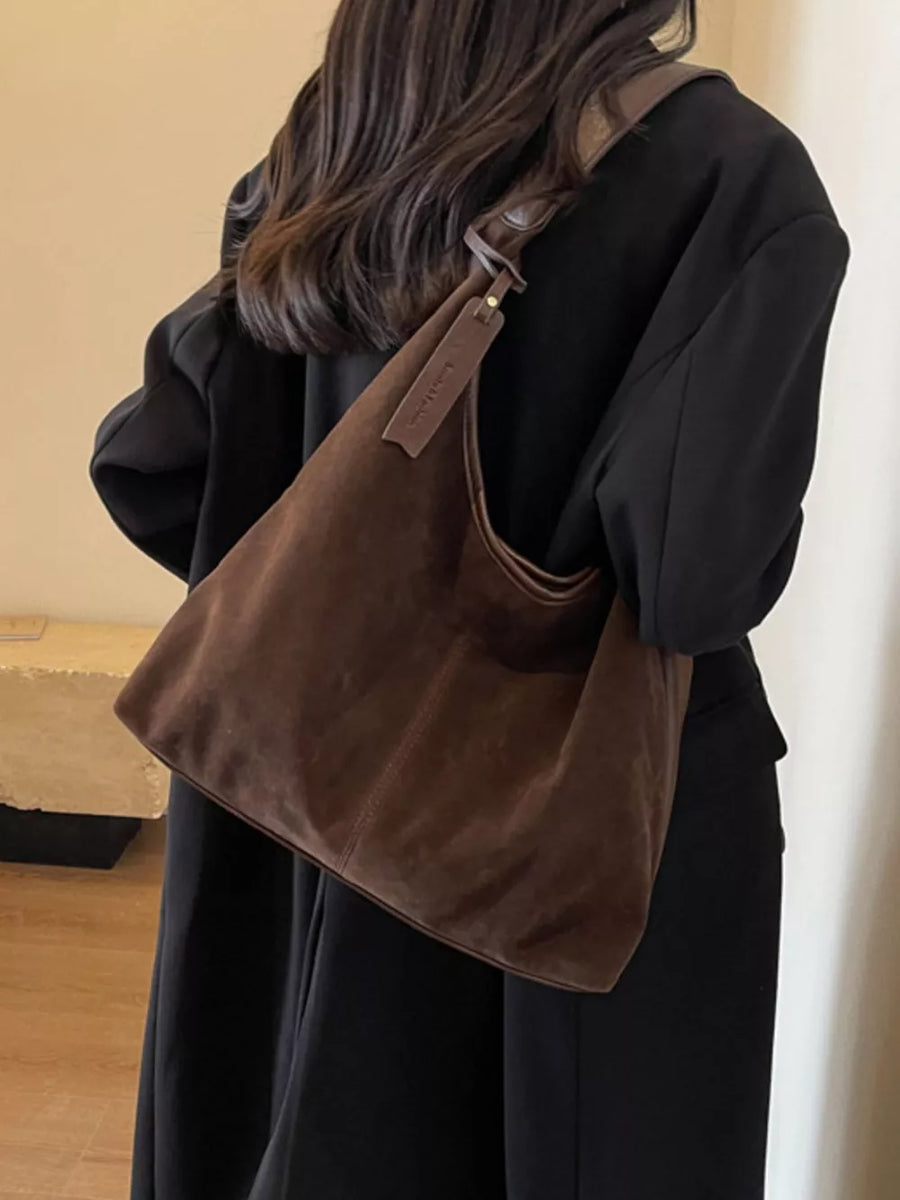 Brown plush corduroy hobo shoulder bag with leather strap detail