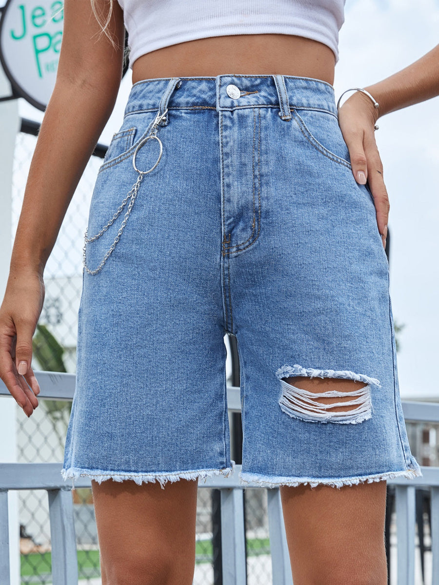 Light wash denim Bermuda shorts with distressed details and chain accent.