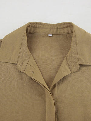 Cropped long sleeve top with collared neckline and button-up front in tan cotton.