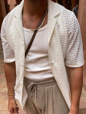 Ivory open-knit herringbone resort shirt with short sleeves and a collared neckline.
