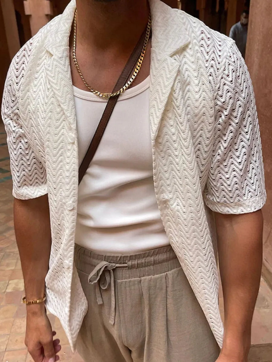 Ivory open-knit herringbone resort shirt with short sleeves and a collared neckline.