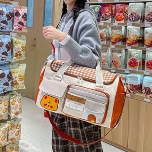 Charming gingham pattern travel bag with double zipper and cute bear applique.
