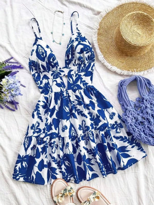 Vibrant floral V-neck mini dress with cutout detail and tiered hem.
