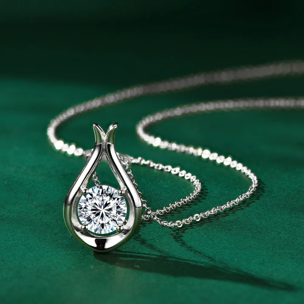 Silver teardrop pendant necklace with a round moissanite stone