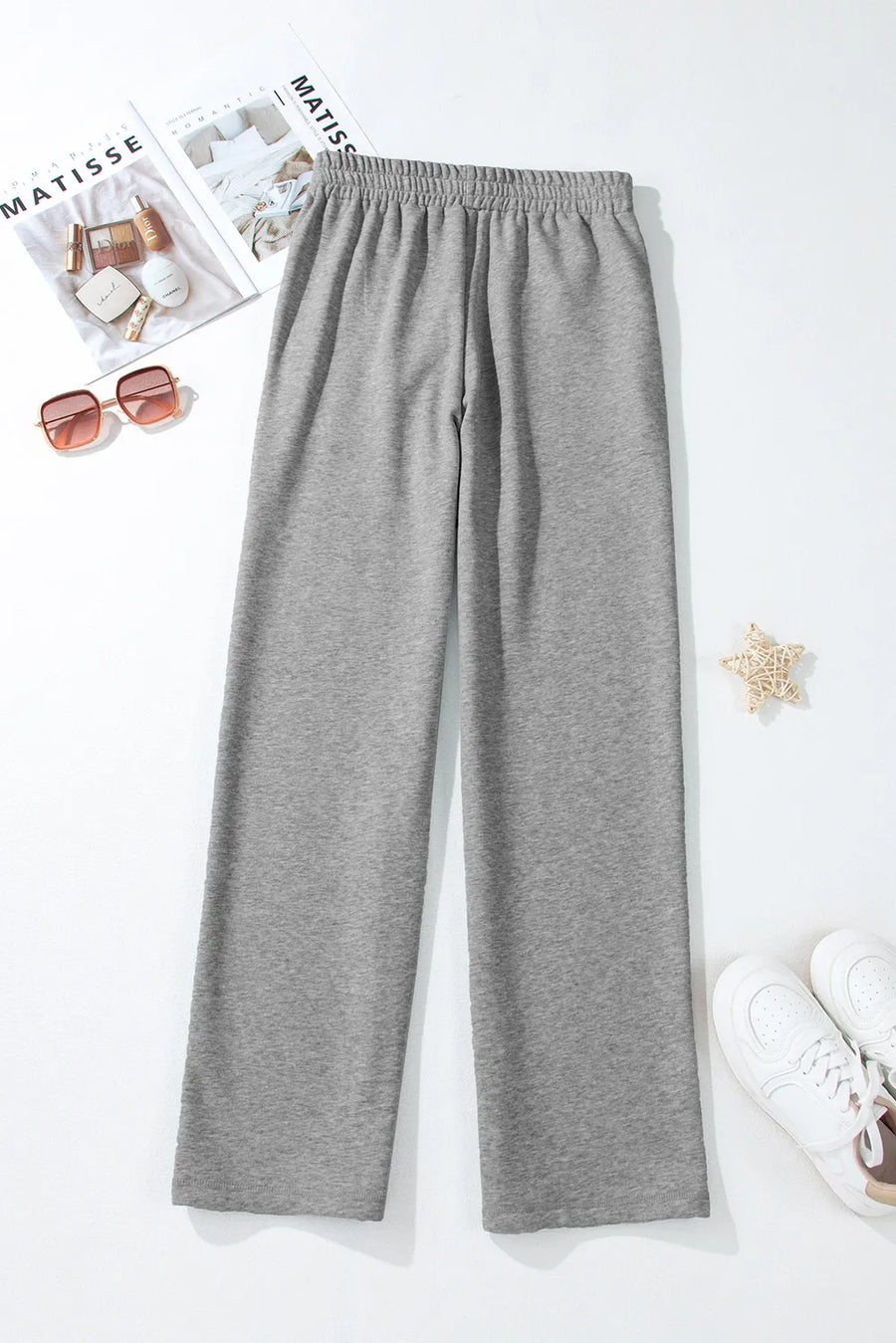 Relaxed-fit grey lounge joggers with elastic waistband and drawstring detail.