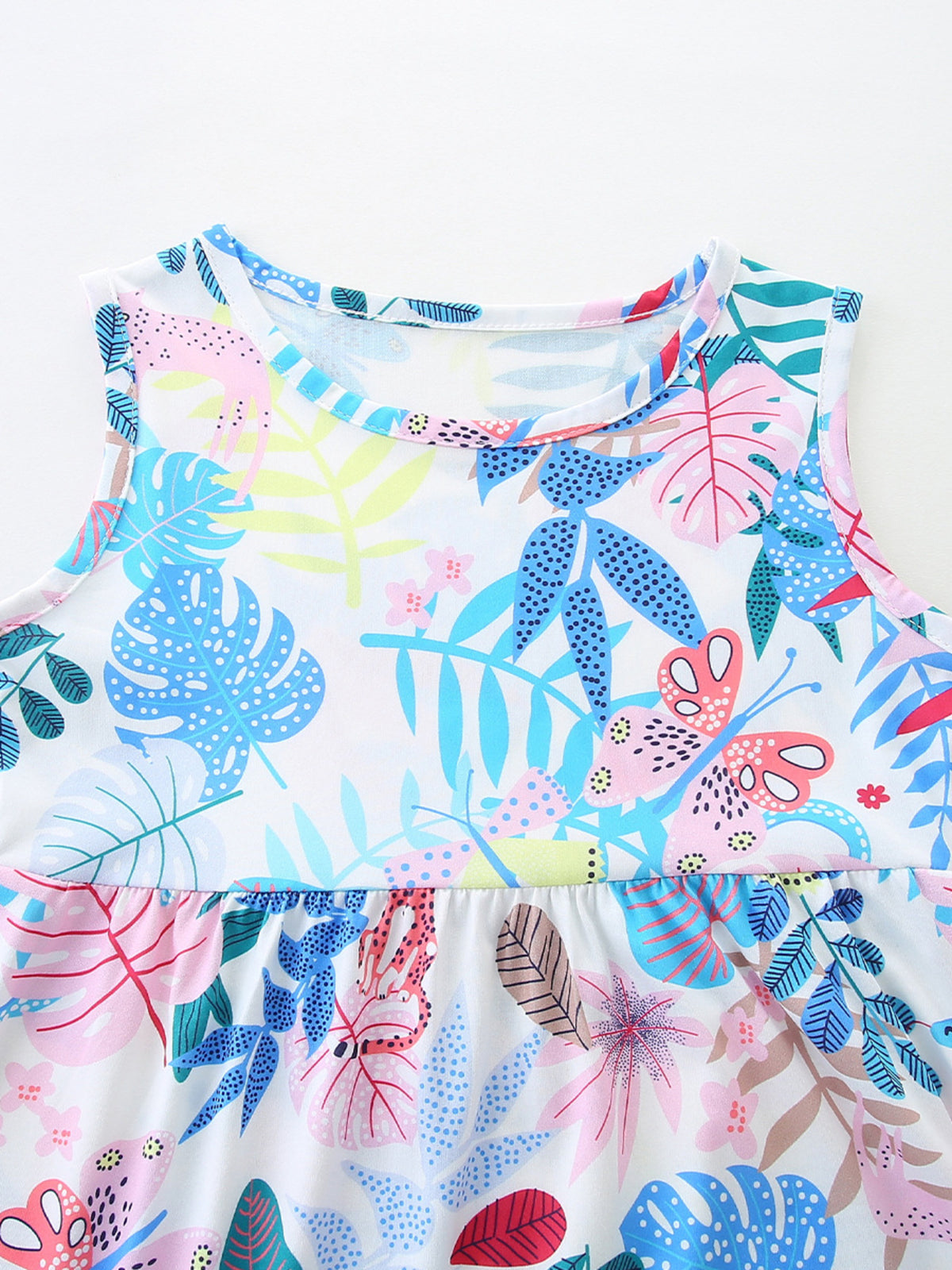 Baby girls cotton dress with playful tropical leaf and butterfly print, round neck, sleeveless.