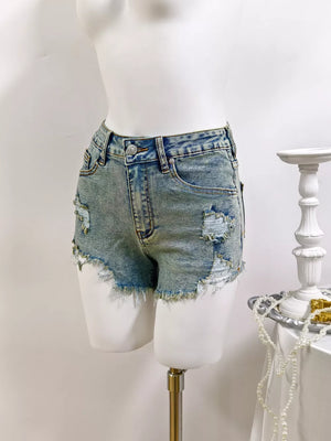 denim shorts in medium blue with distressed and mini