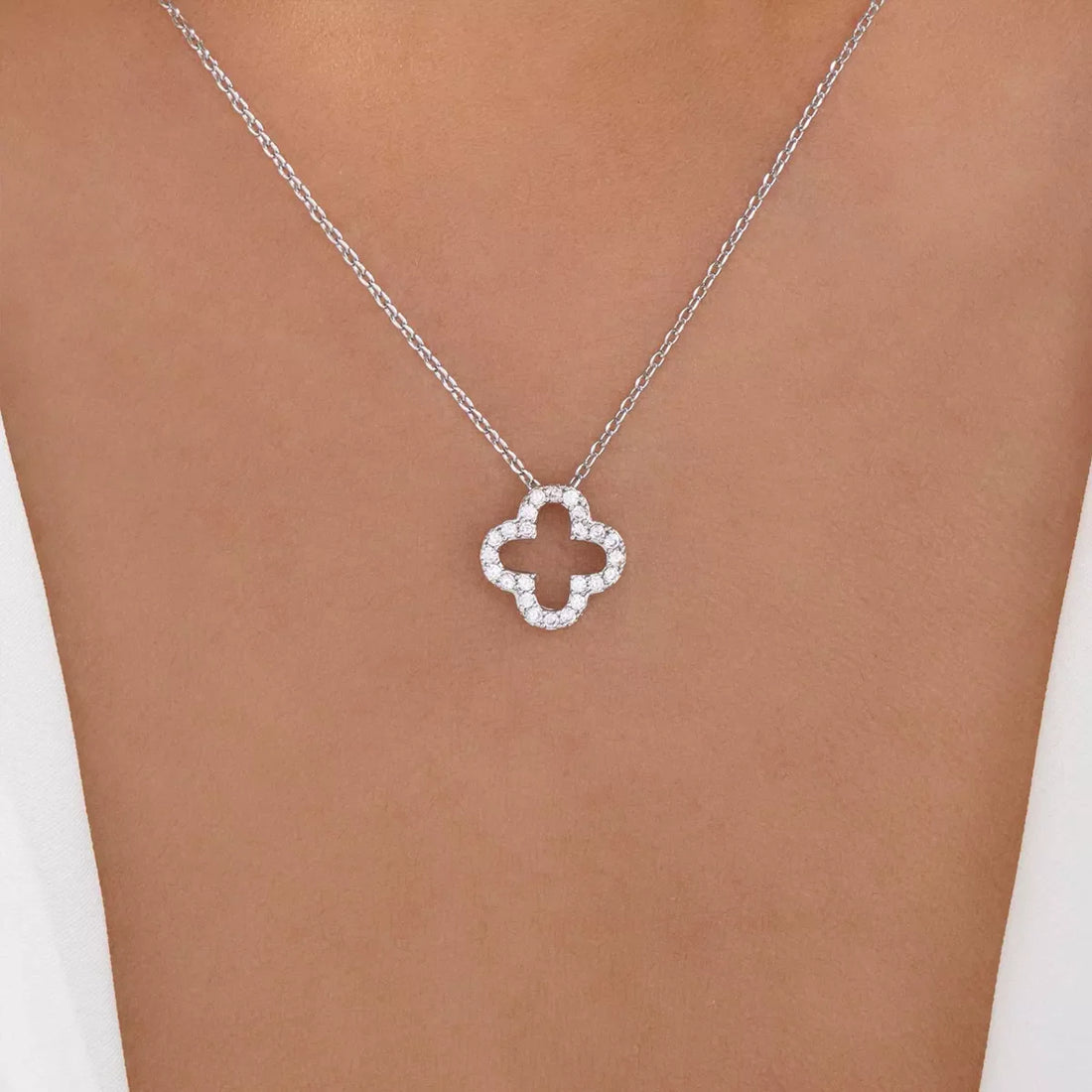 Silver clover pendant necklace with clear stones on a delicate chain