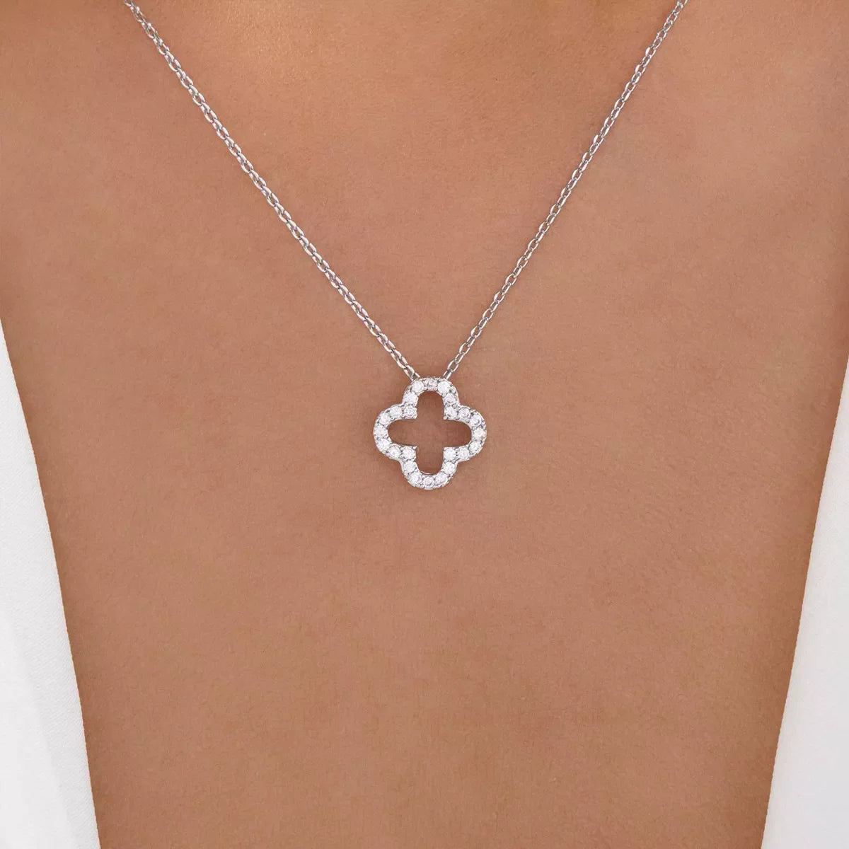 Silver clover pendant necklace with clear stones on a delicate chain