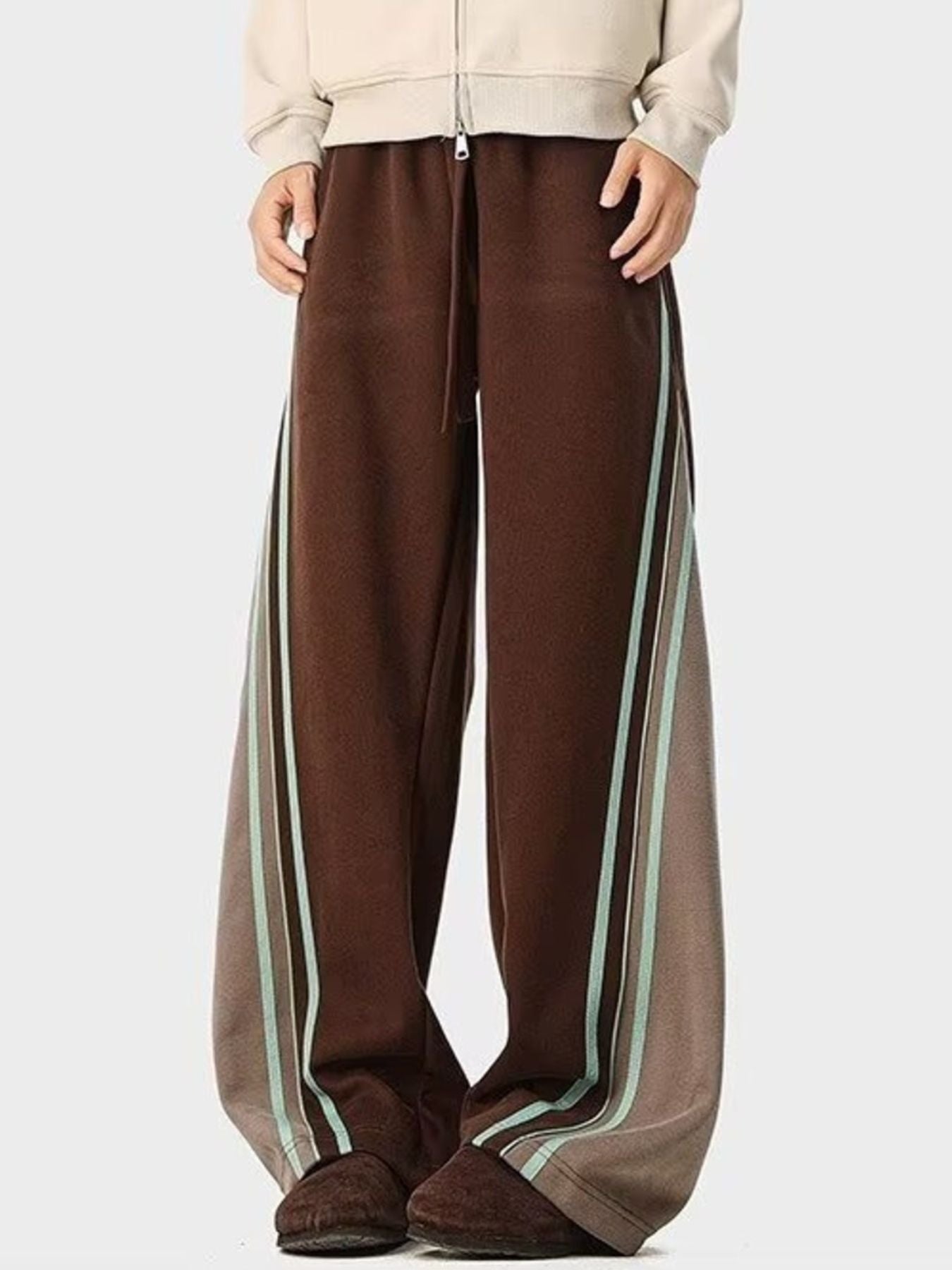 Brown drawstring joggers with contrasting side stripes and a relaxed fit.