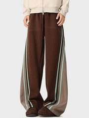 Brown drawstring joggers with contrasting side stripes and a relaxed fit.