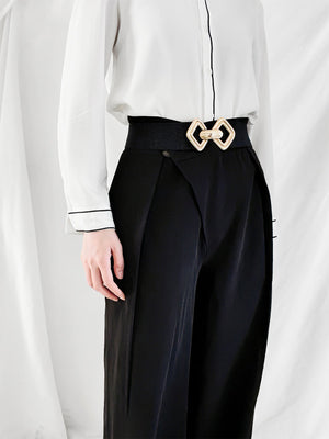 Black elasticated waist belt with gold geometric buckle detail