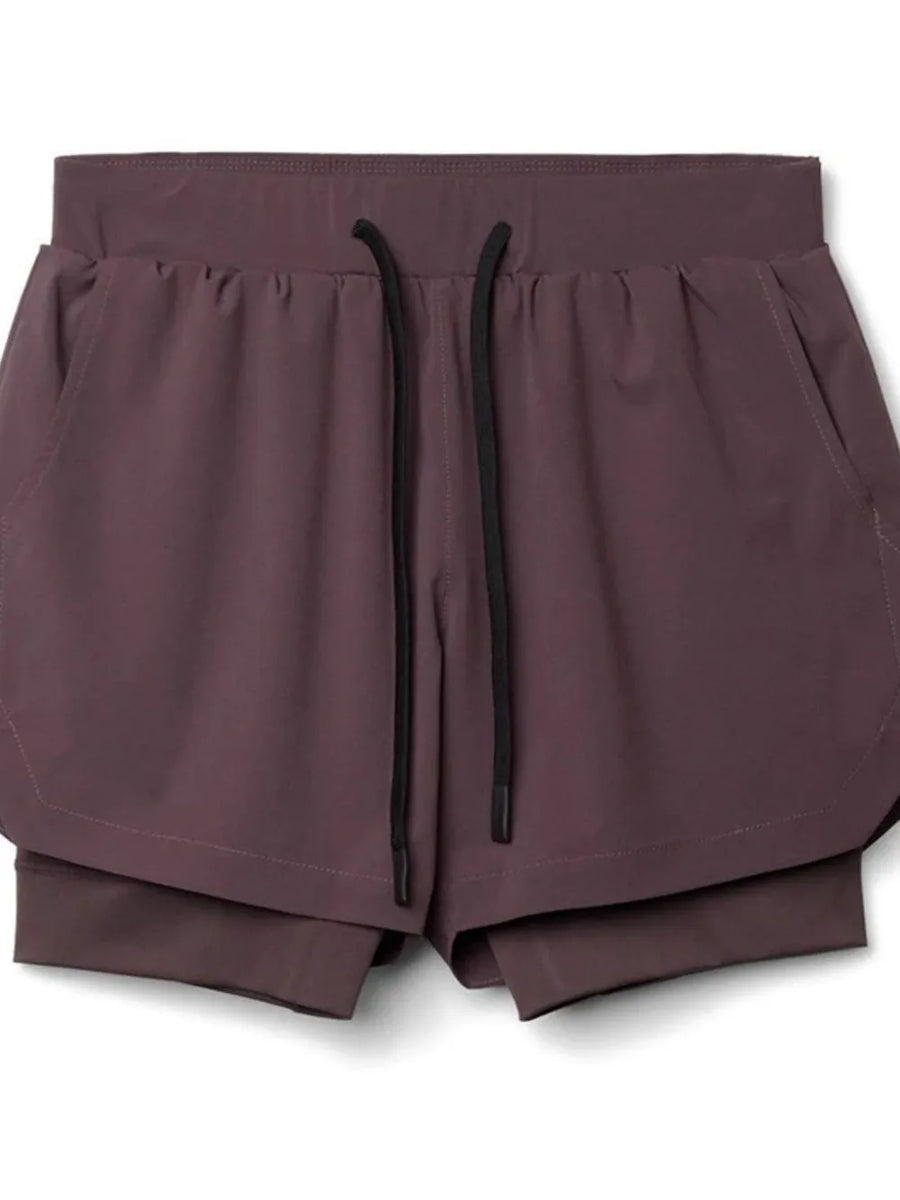 Layered performance shorts in plum purple with drawstring and perforated panels.