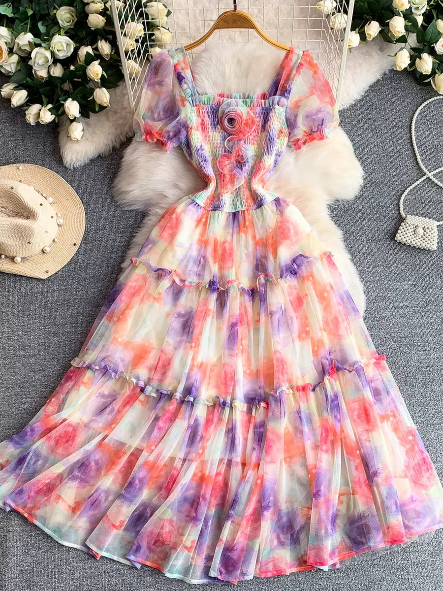 Floral tiered midi dress with smocked bodice, square neck, puff sleeves, and watercolor print.