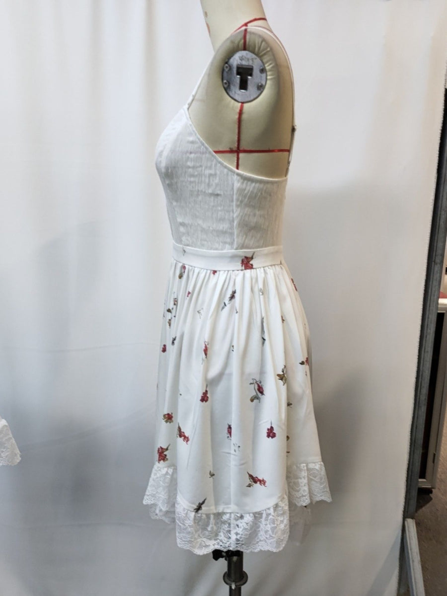 White floral print cami dress with lace trim and sweetheart neckline.