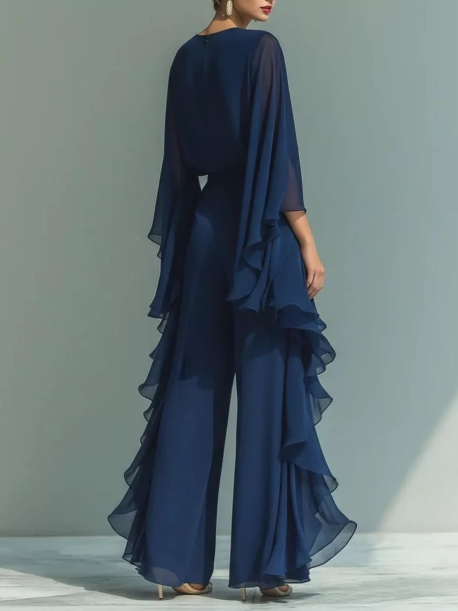 Navy blue chiffon wide-leg pants with cascading ruffles and a matching cape top.