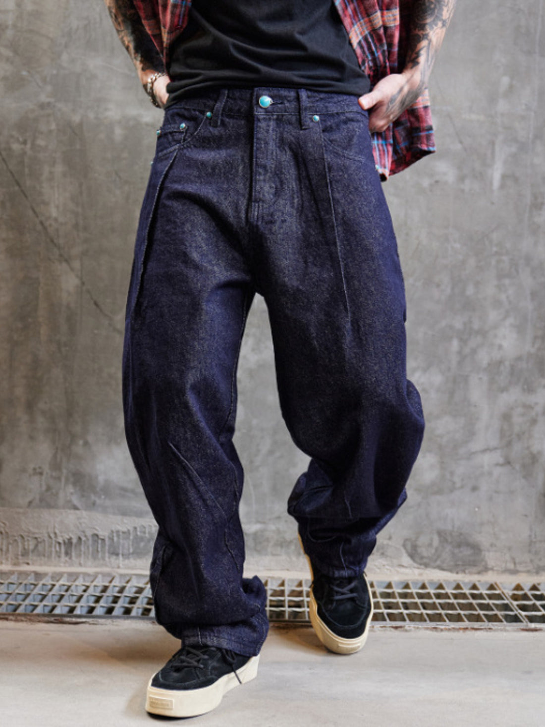 Men's wide leg indigo denim jeans with a baggy fit and dark wash.