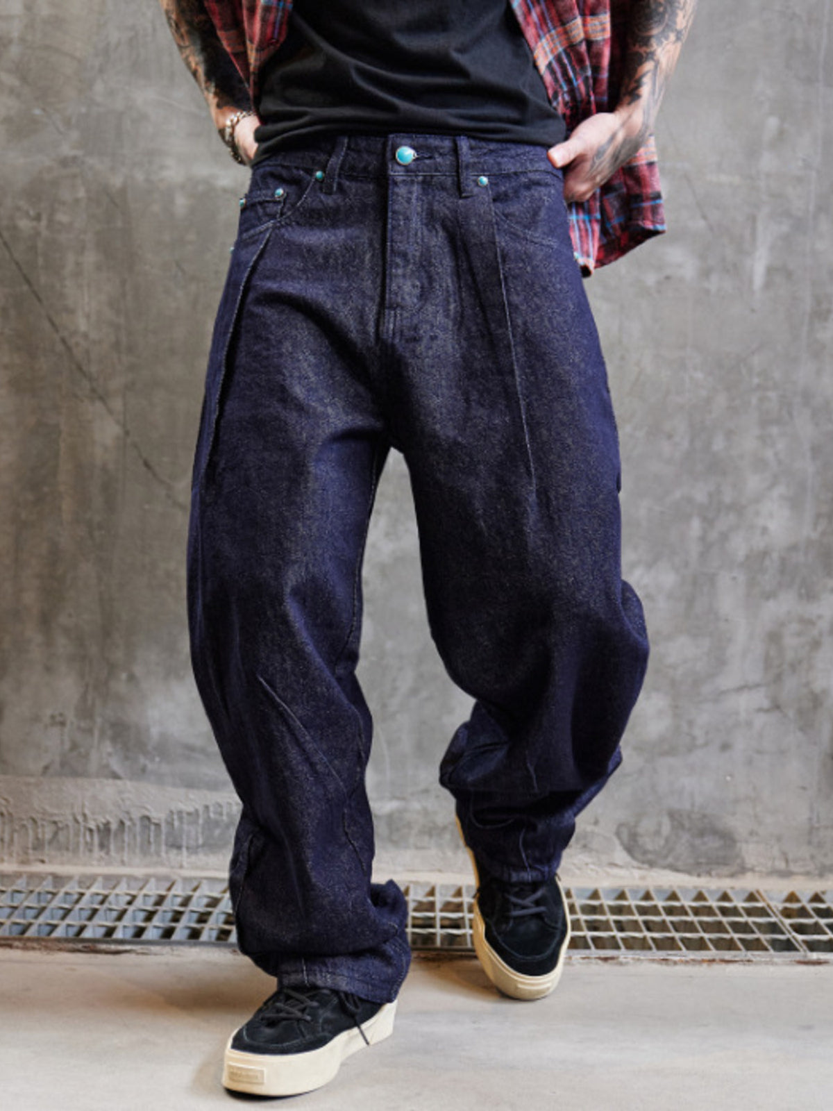 Men's wide leg indigo denim jeans with a baggy fit and dark wash.