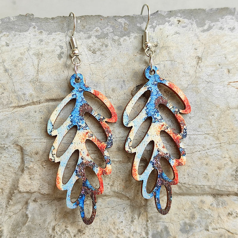 Patina leaf laser-cut drop earrings with blue, orange, and brown distressed pattern