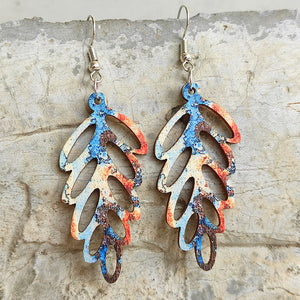 Patina leaf laser-cut drop earrings with blue, orange, and brown distressed pattern
