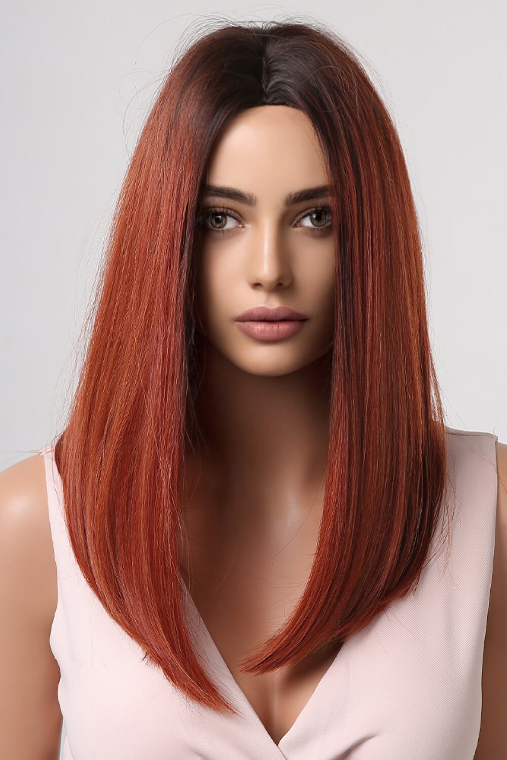 Auburn ombre center-parted wig with copper brown roots and a sleek bob cut.
