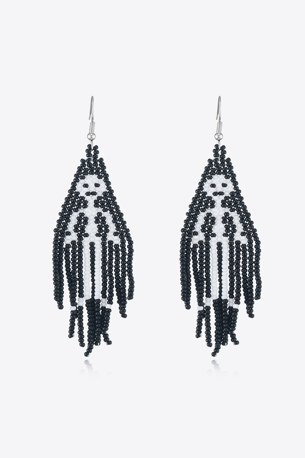 Black and white beaded ghost fringe earrings with dangling strands.