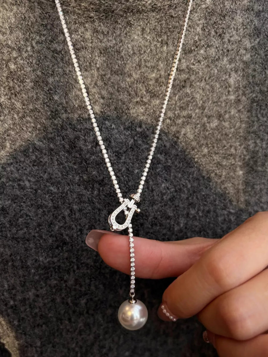 Lustrous pearl drop Y-necklace with diamond chain and clasp detail.