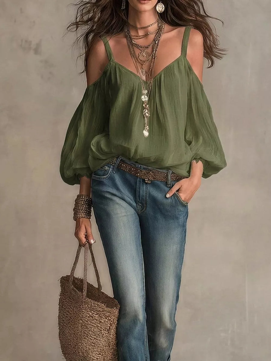 Army green cold shoulder shirt with balloon sleeves and V-neck, styled with jeans and jewelry.