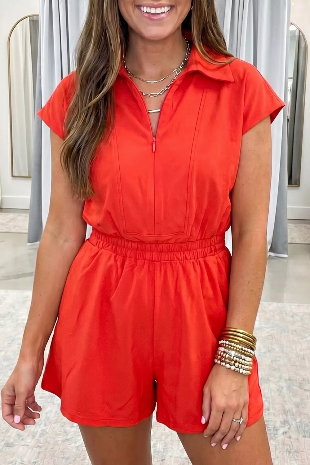 Red cotton romper with polo collar, zip front, short sleeves, and elastic waist.